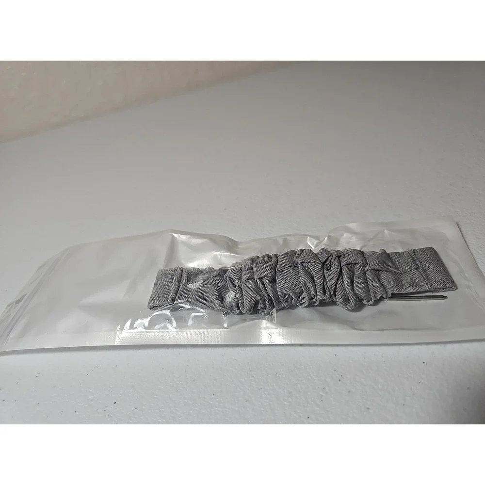 Scrunchie-style watch band for a fitness tracker, made of a Gray, ruched fabric
